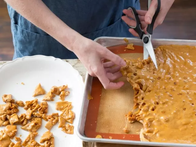 breaking the peanut brittle in pieces 